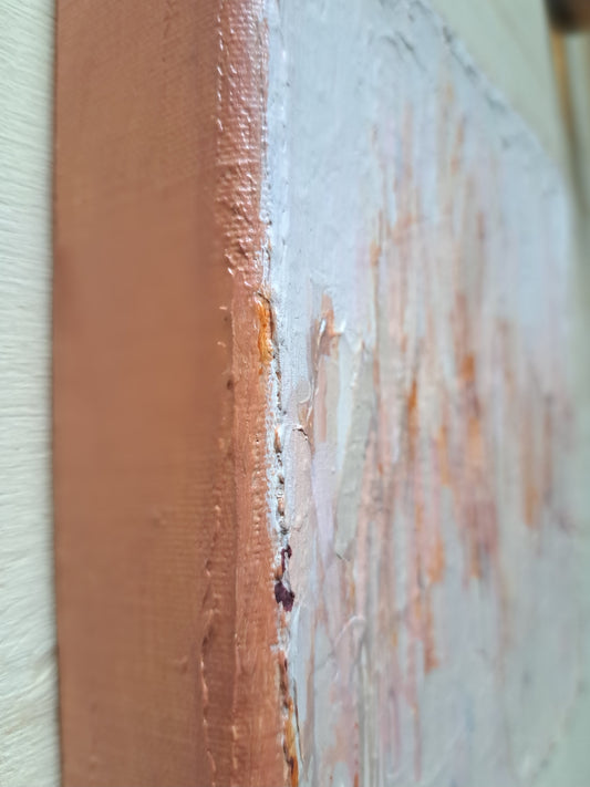 Close-up of a textured painting showing a vertical edge with thick impasto brushstrokes in warm peach, pink, and off-white tones.