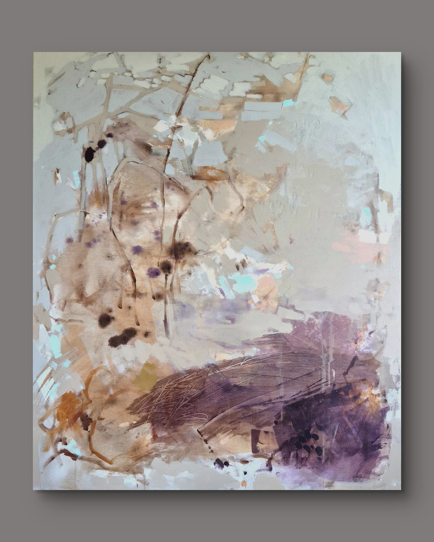 An abstract canvas painting featuring textured brushstrokes in beige, brown, purple, and soft blue tones, displayed against a solid gray background.