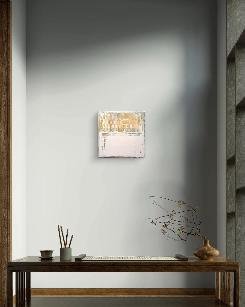 Modern wall-mounted light fixture on a gray wall above a wooden desk.