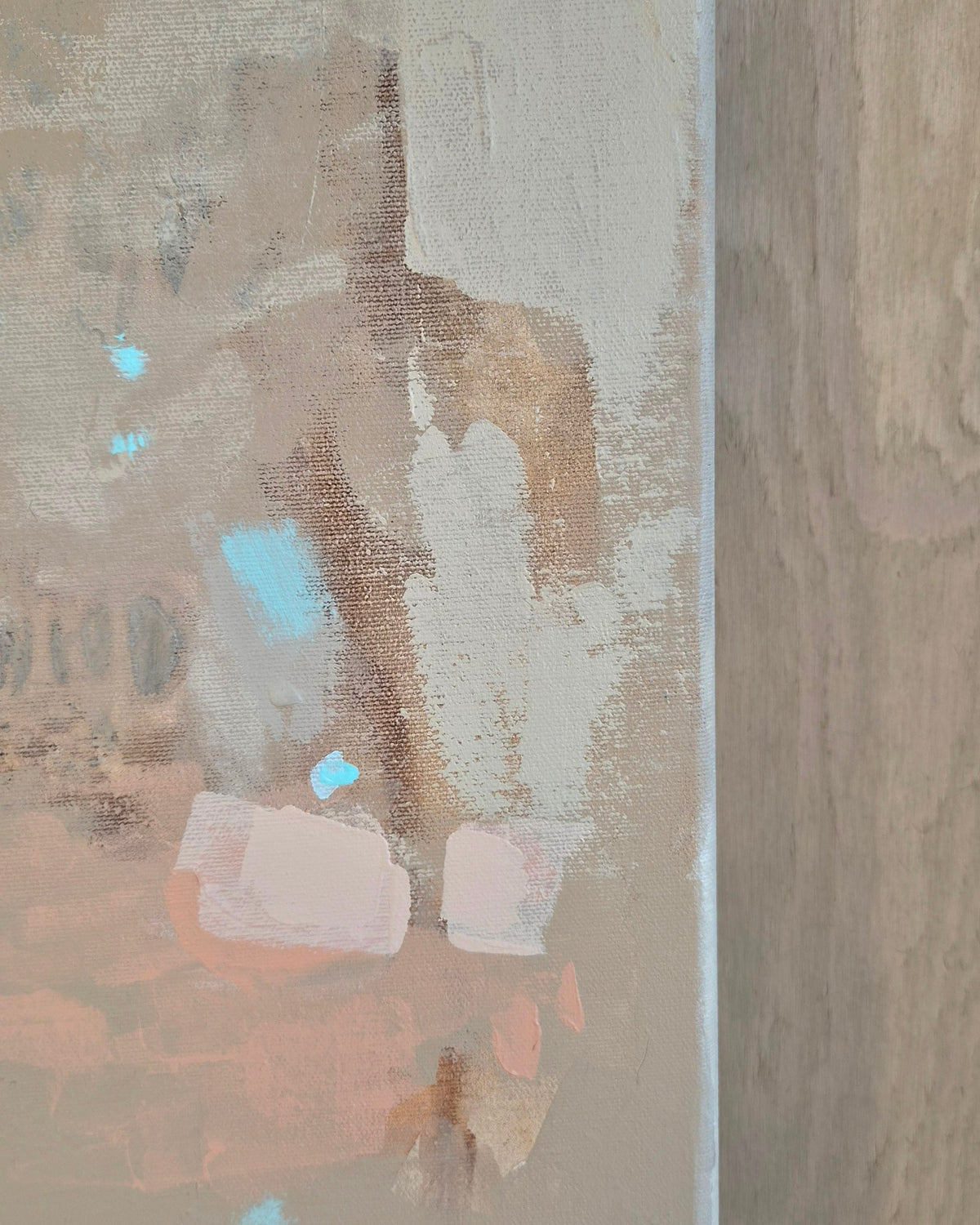 Abstract textured painting with layered brushstrokes in beige, taupe, soft pink, light blue, and brown, shown close up with a vertical painted edge on the right.