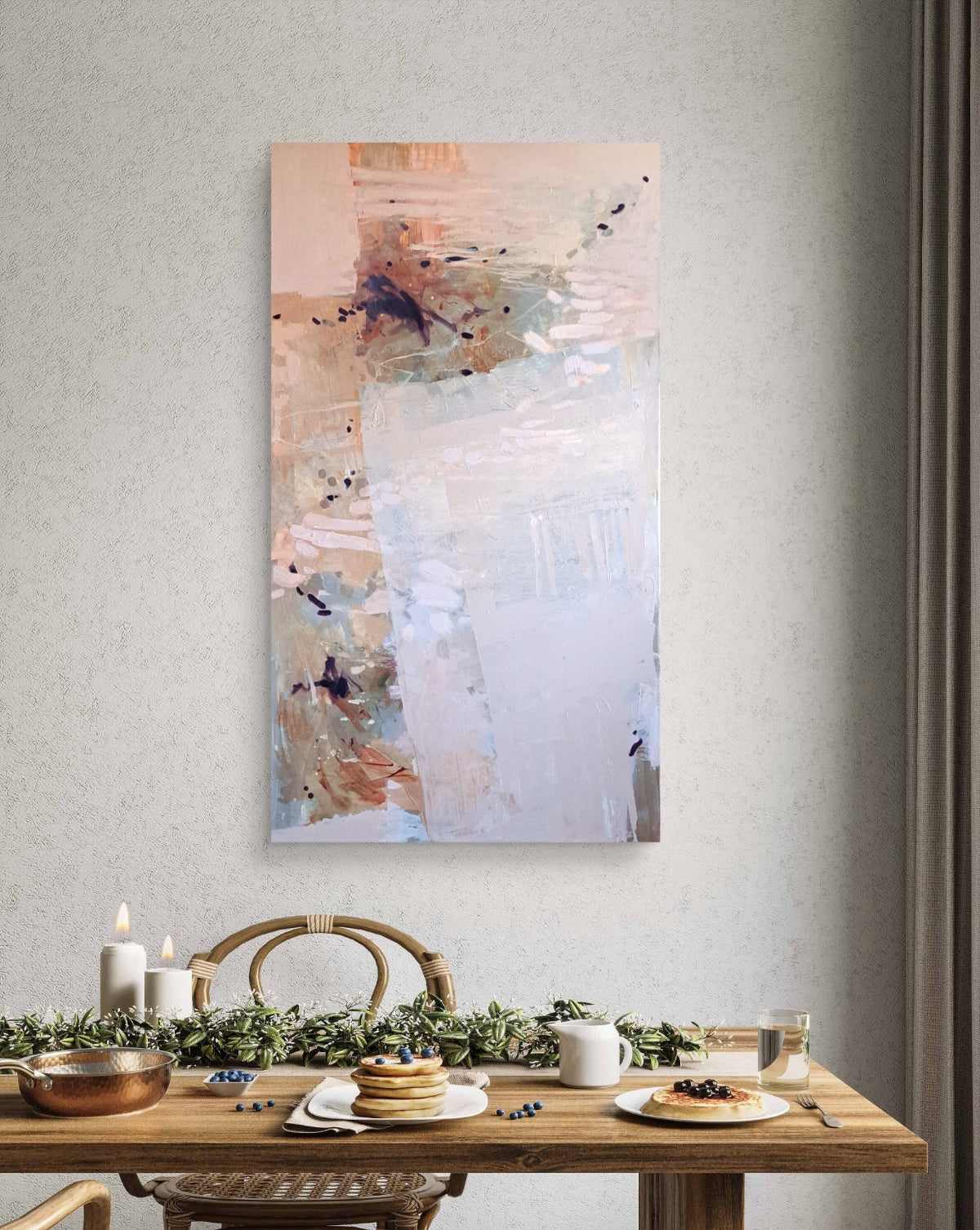 Abstract painting on a wall above a dining table with a Christmas setting.