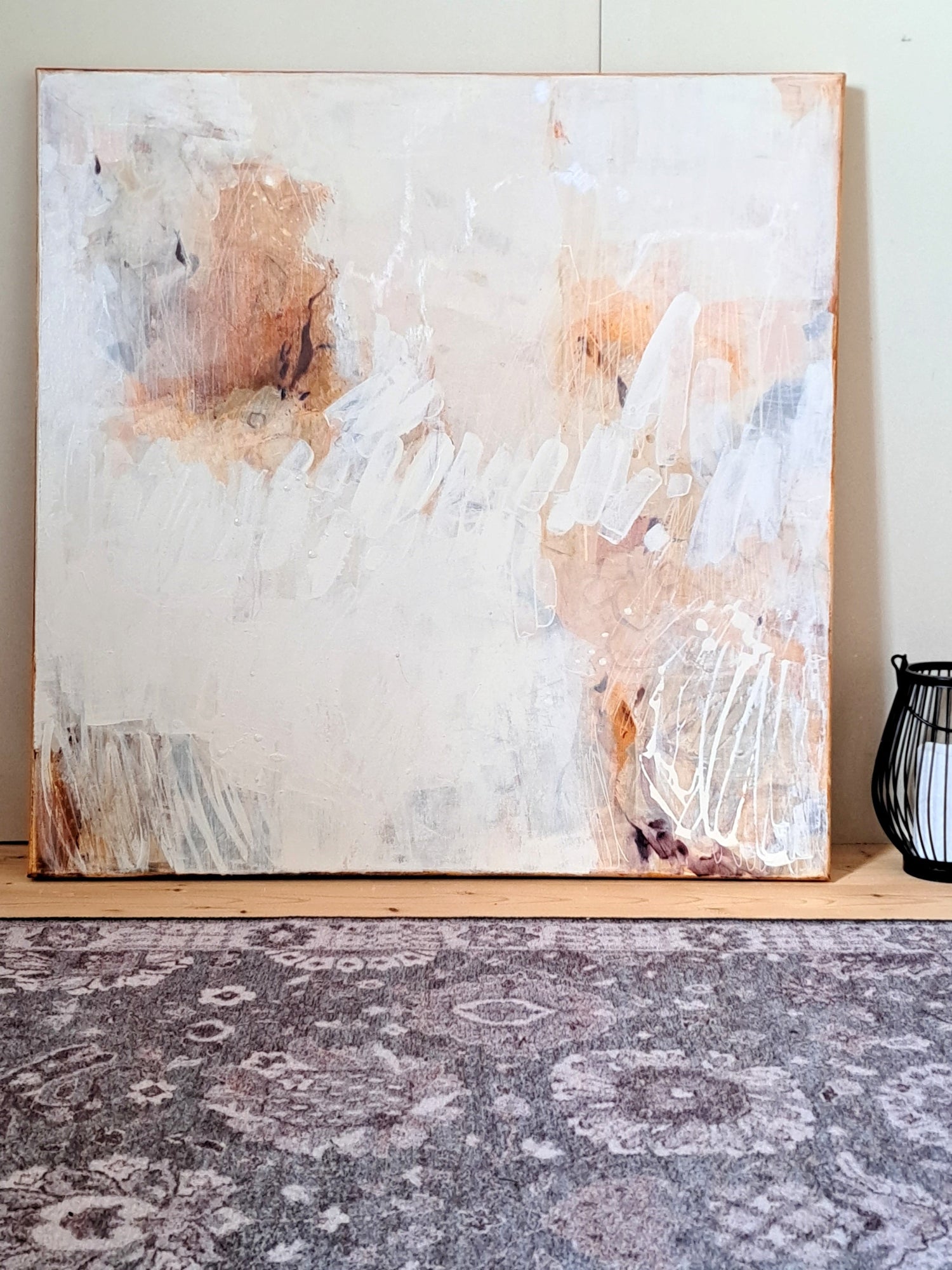 Abstract painting on a wall with a textured floor below