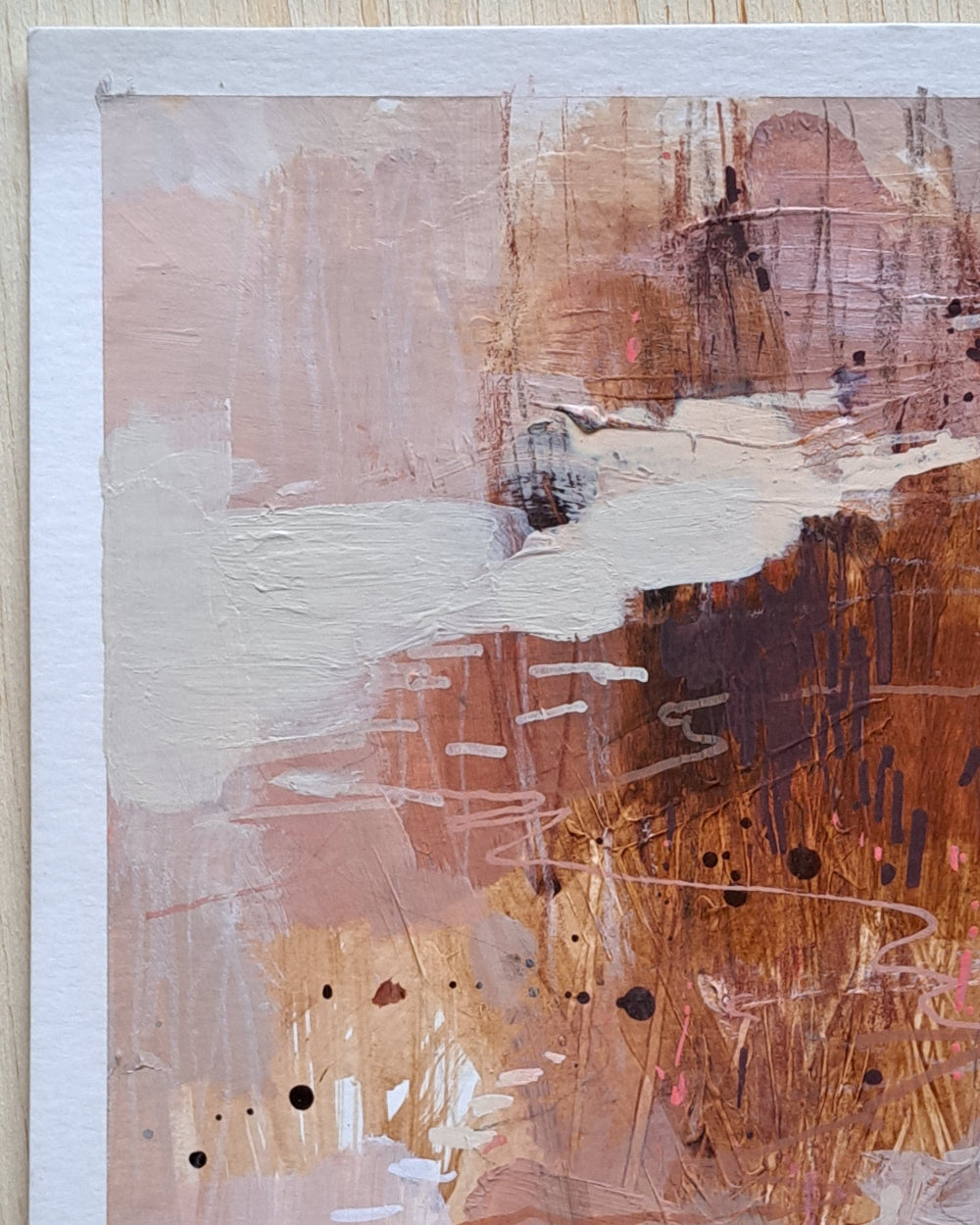 Abstract art piece with brown, white, and beige colors on a textured surface.