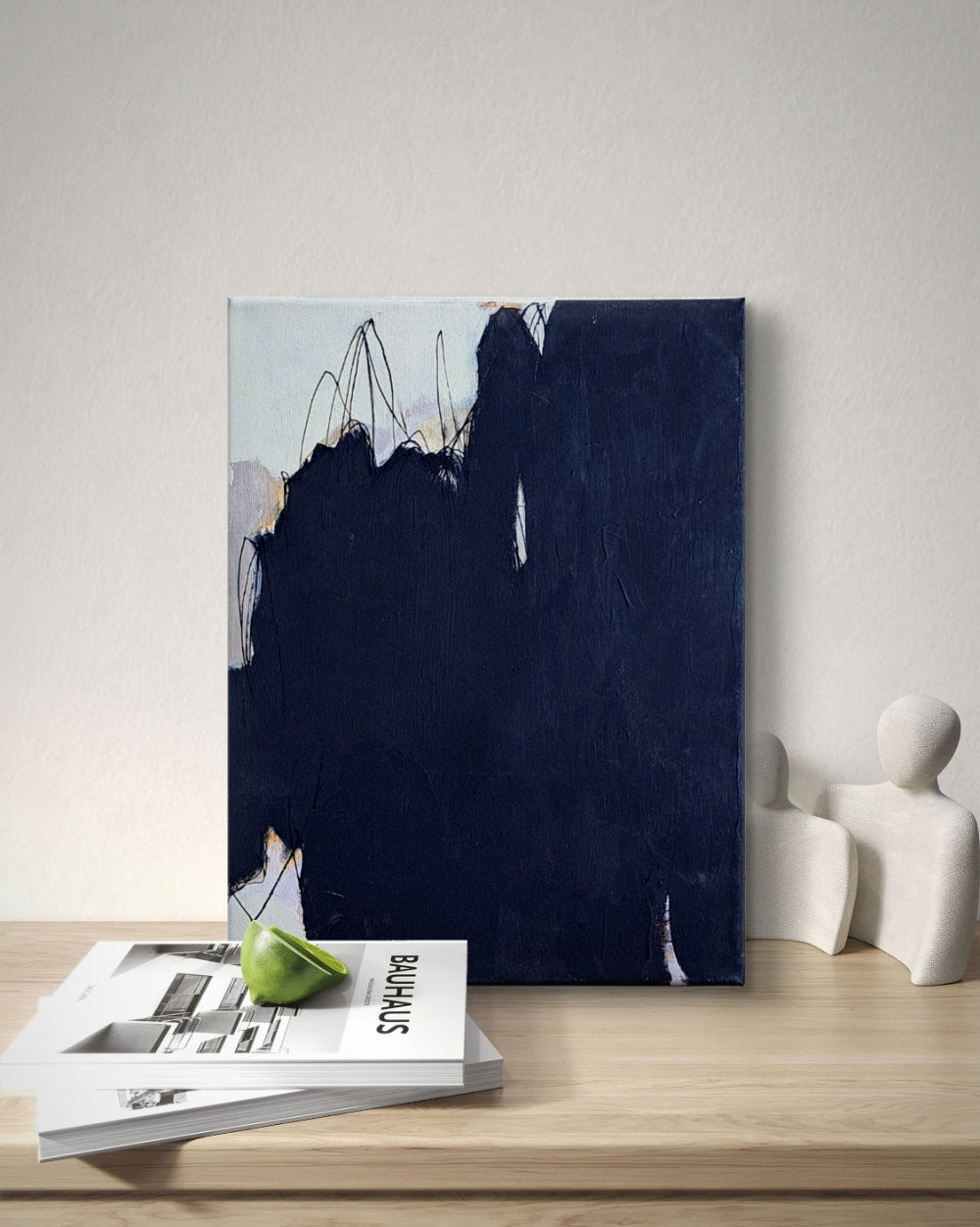 Abstract painting on a wooden surface with a minimalist decor setup.