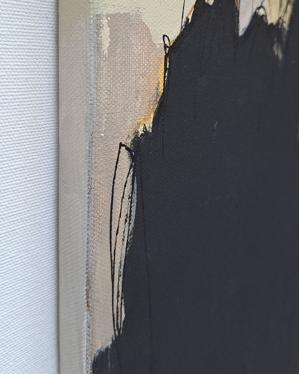 Abstract art with black, white, and gray brush strokes on a textured surface.