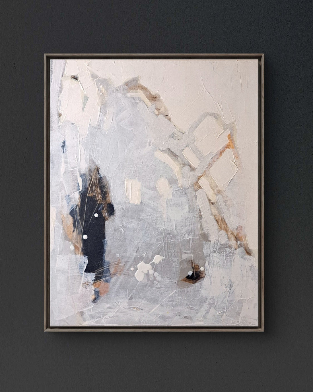Abstract painting in a black frame on a dark wall